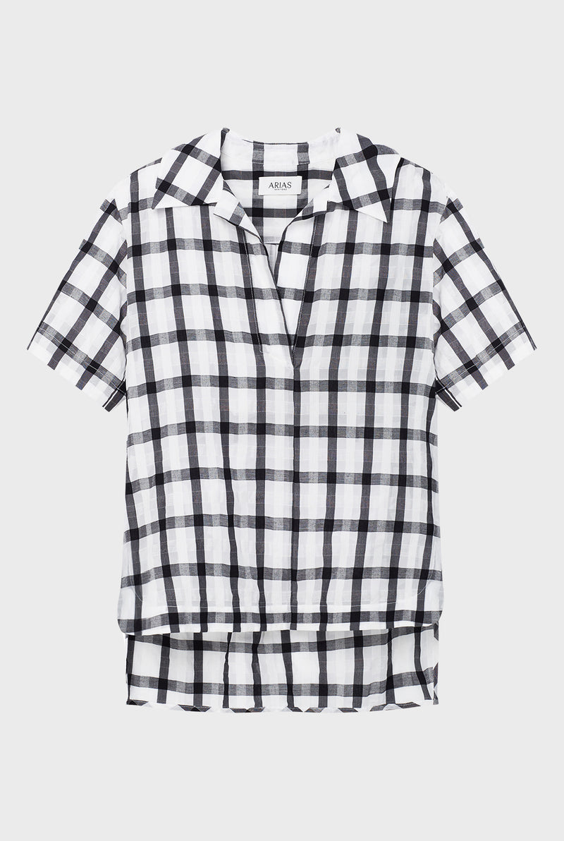 ARIAS' collections fall in that sweet spot between statement and classic and include the clothes we often need to reach for on a daily basis. Made from an airy cotton-voile Italian fabric, this Checked Tunic Top showcases an artful, curved high-low hem and impeccable fit.